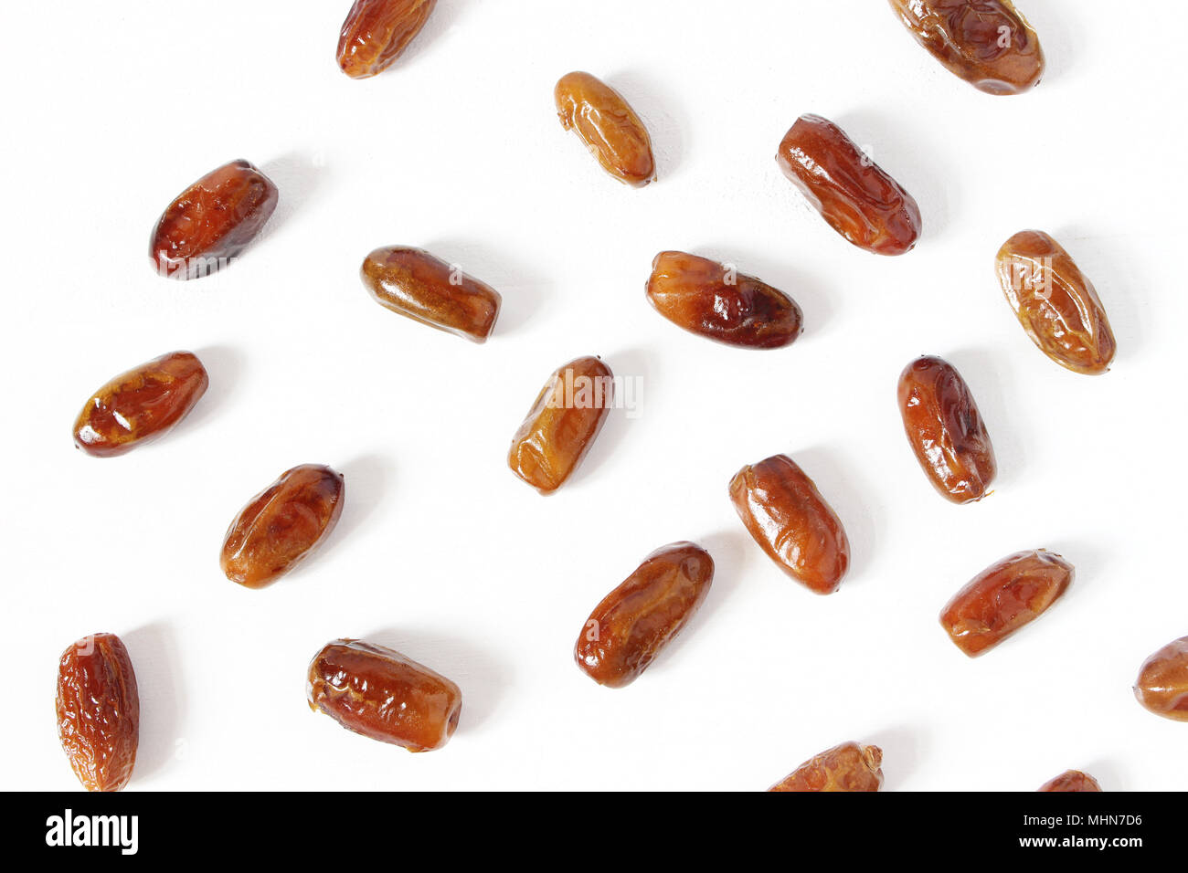 Styled stock photo. Ramadan desktop composition with date fruit on white background. Food pattern. Empty space. Flat lay, top view. Stock Photo