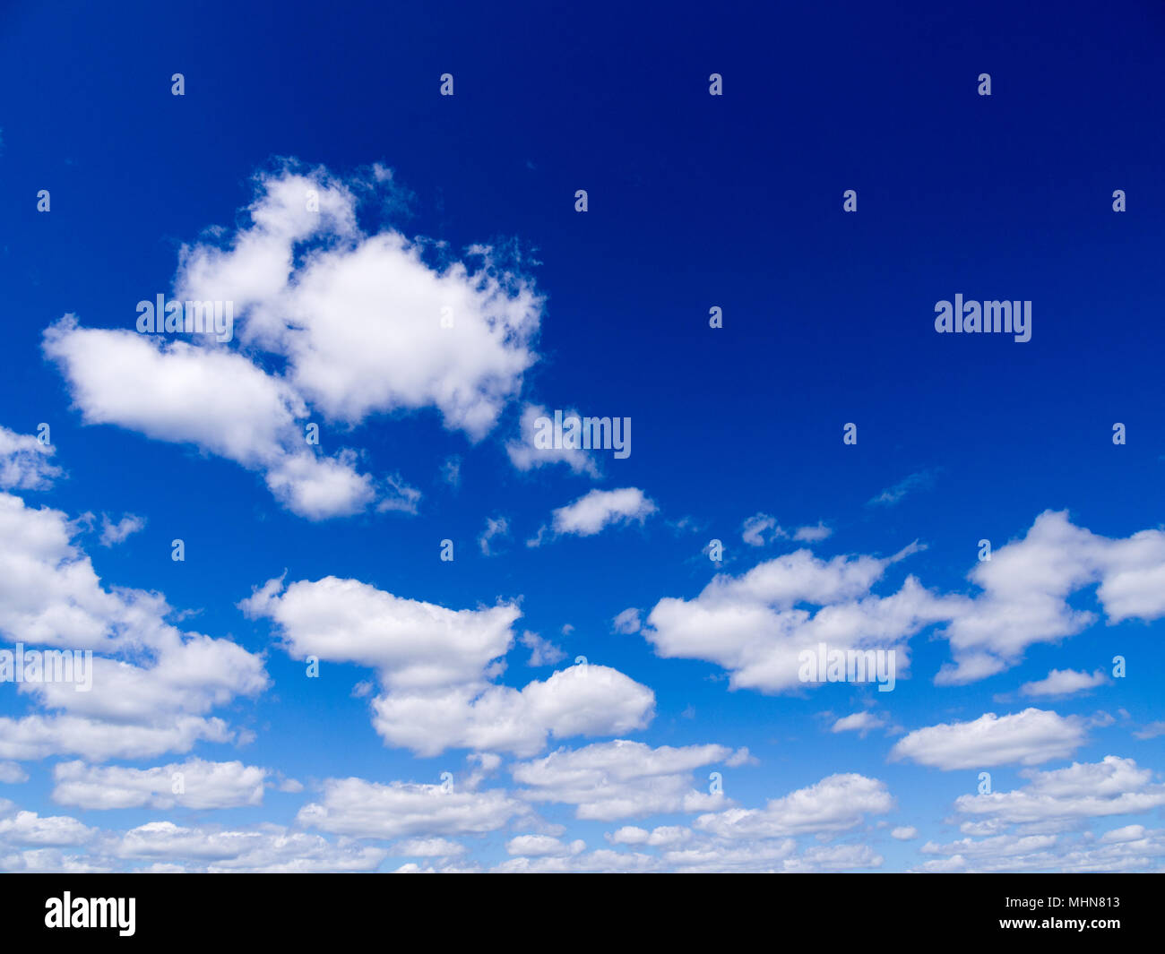 Blue sky with white fluffy clouds Stock Photo - Alamy