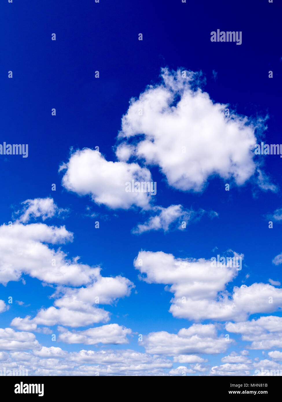 Blue sky with white fluffy clouds Stock Photo
