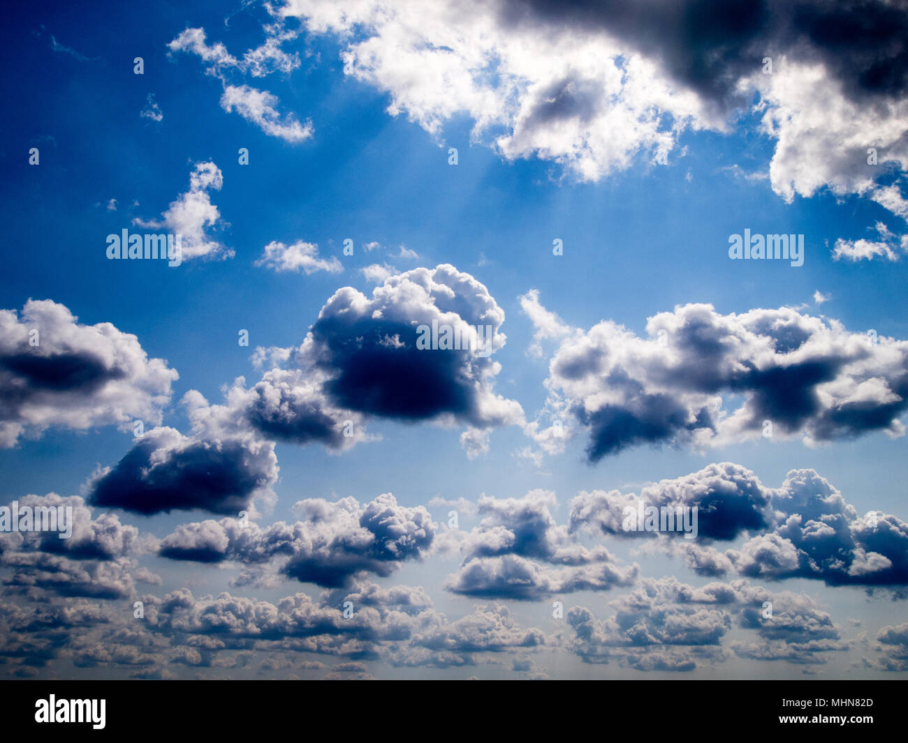 Blue sky with white fluffy clouds Stock Photo - Alamy