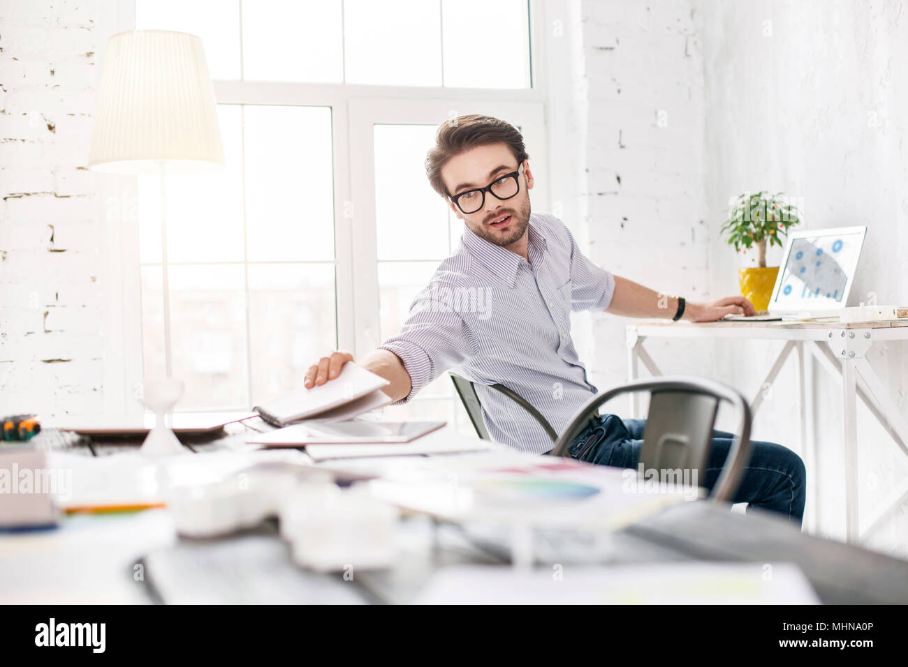 Alert manager working on his computer Stock Photo - Alamy