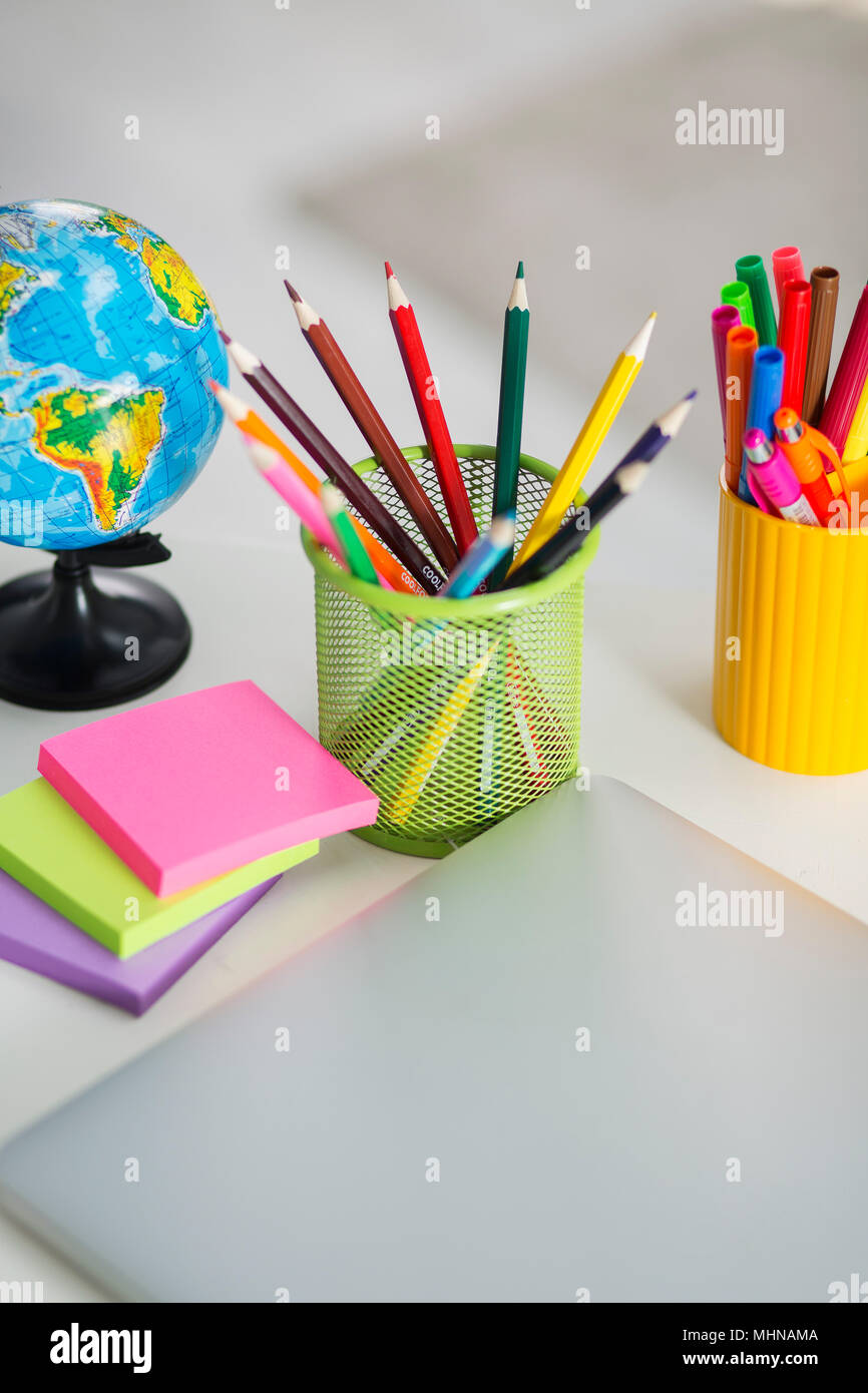 White office desk table with school accessories with office supplies