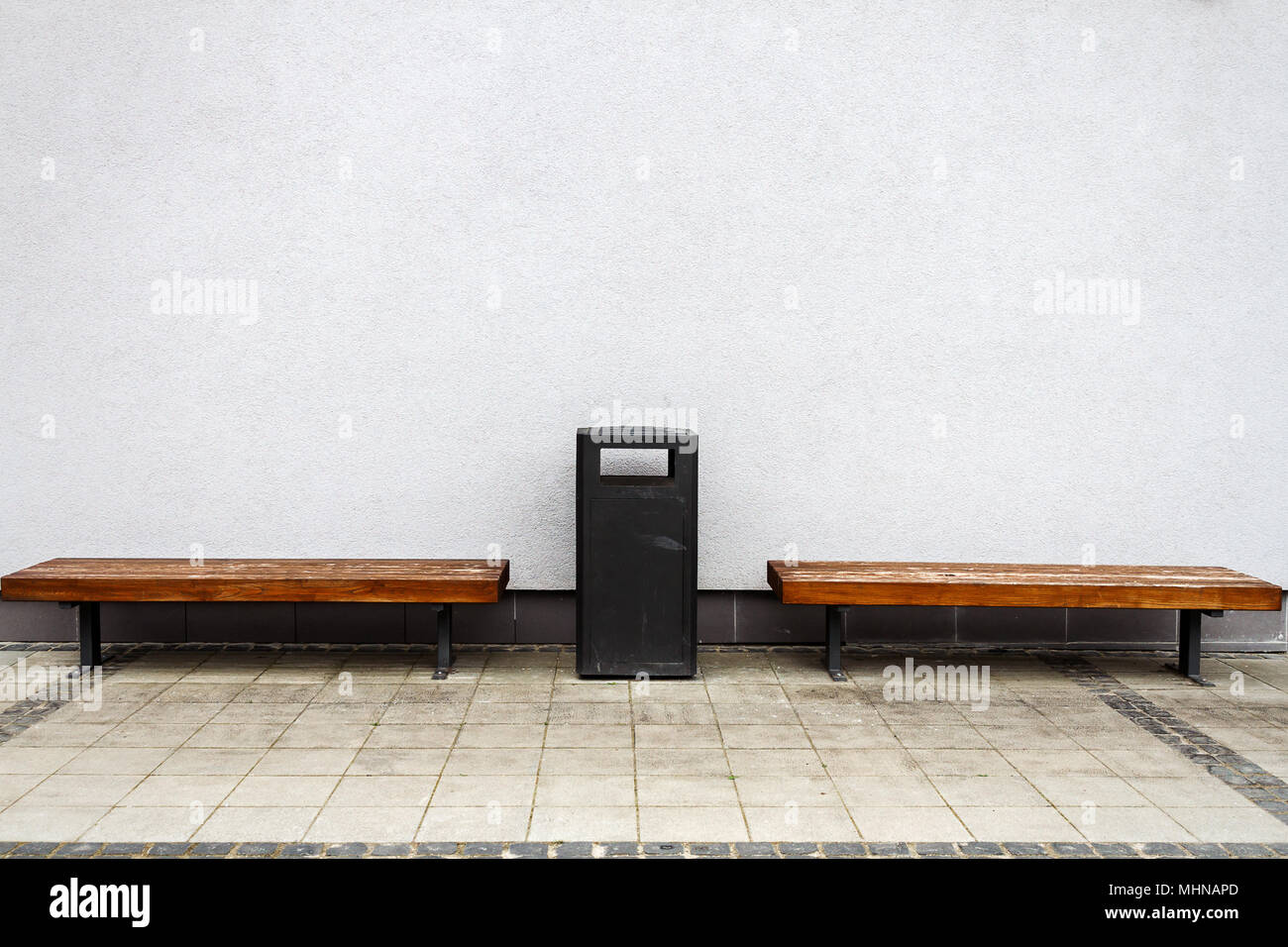 Two wooden benches by a street wall. Architecture detail background ...