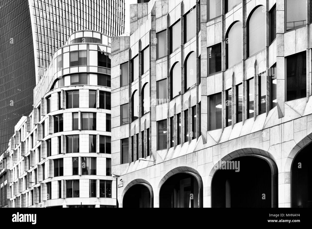 Old and new buildings abstract. Great Tower Street, London, England. Black and white Stock Photo