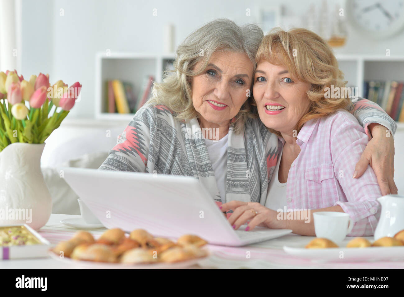 two Senior women using laptop Stock Photo - Alamy