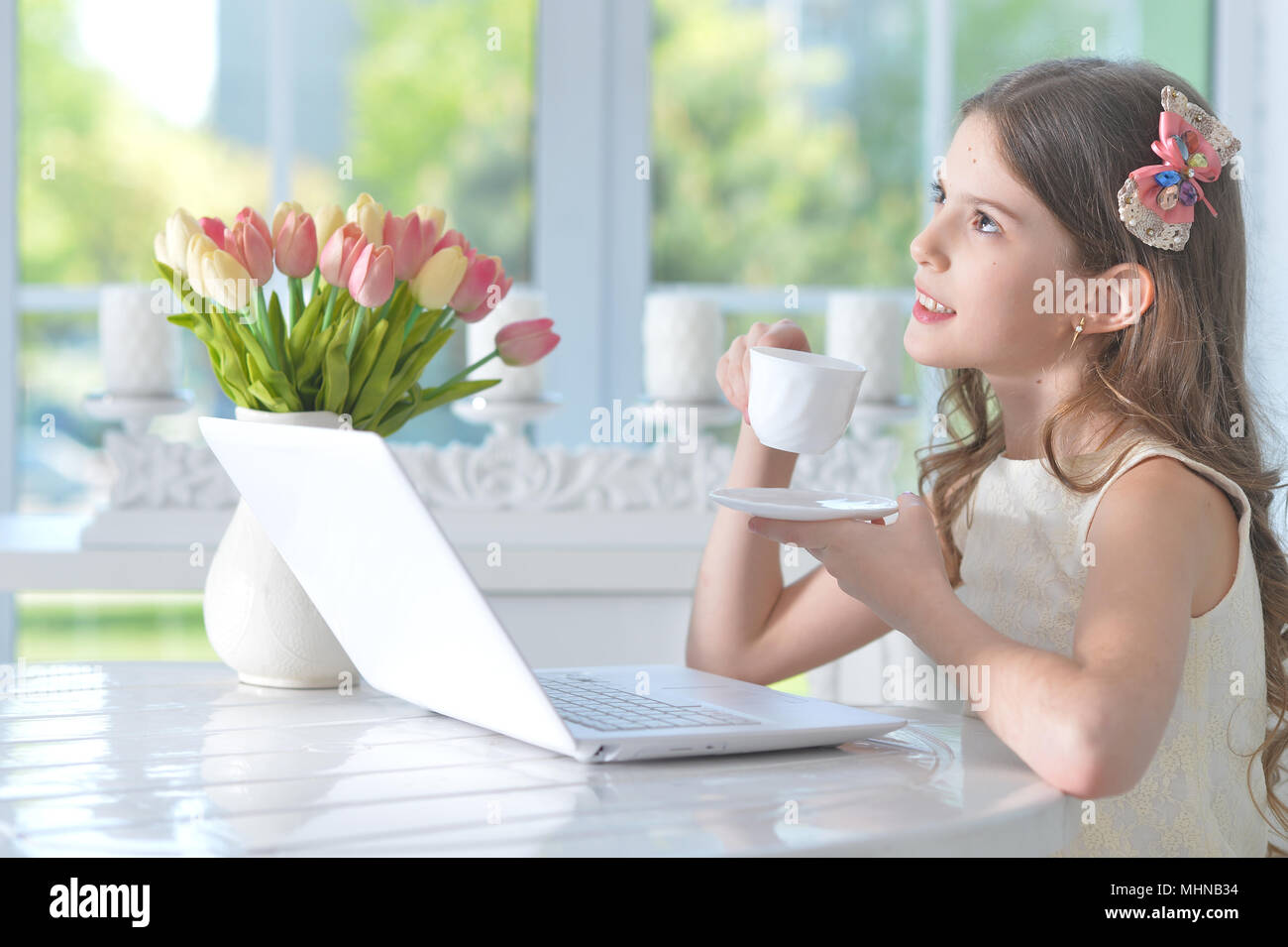 Cute little girl with modern laptop Stock Photo - Alamy