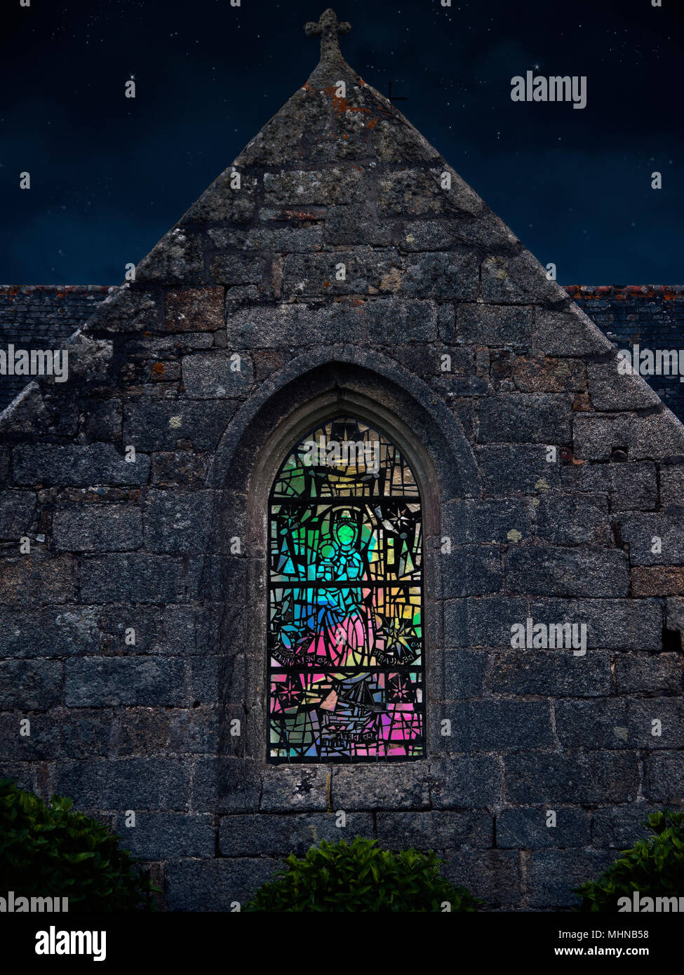 Chapelle de Tremorvezen, Kerascoët, Nevez, Finistere, Brittany, France Illuminated stained glass window exterior at night, Stock Photo