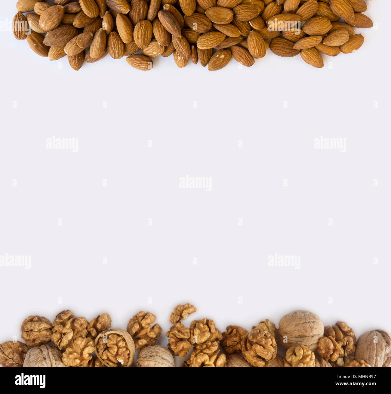 Almonds and walnuts at border of image with copy space for text