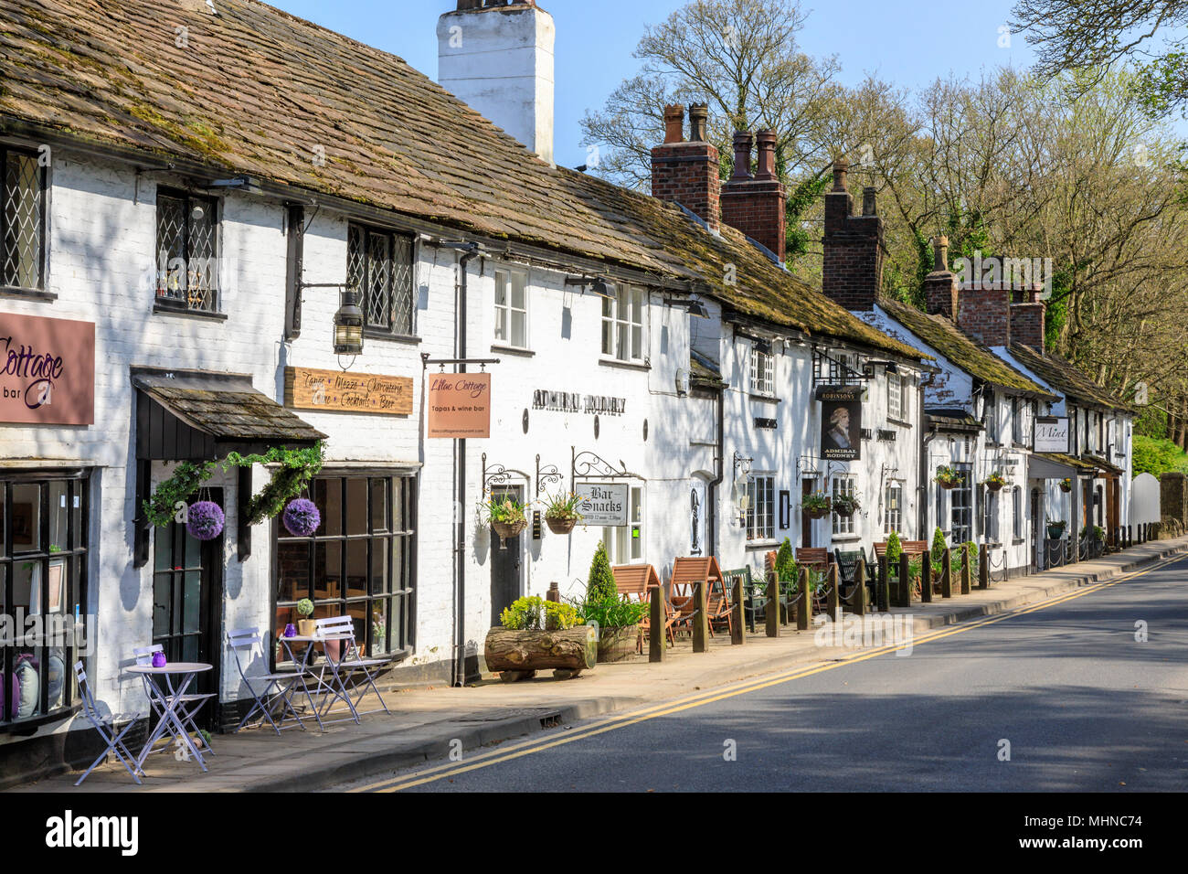 Prestbury is a historic village in Cheshire East.  This is the main street with shops and restaurants Stock Photo