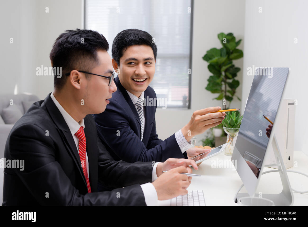 Team work process. Photo young business crew working with new startup project. Project managers meeting. Analyze plans, papers. Blurred background, fi Stock Photo