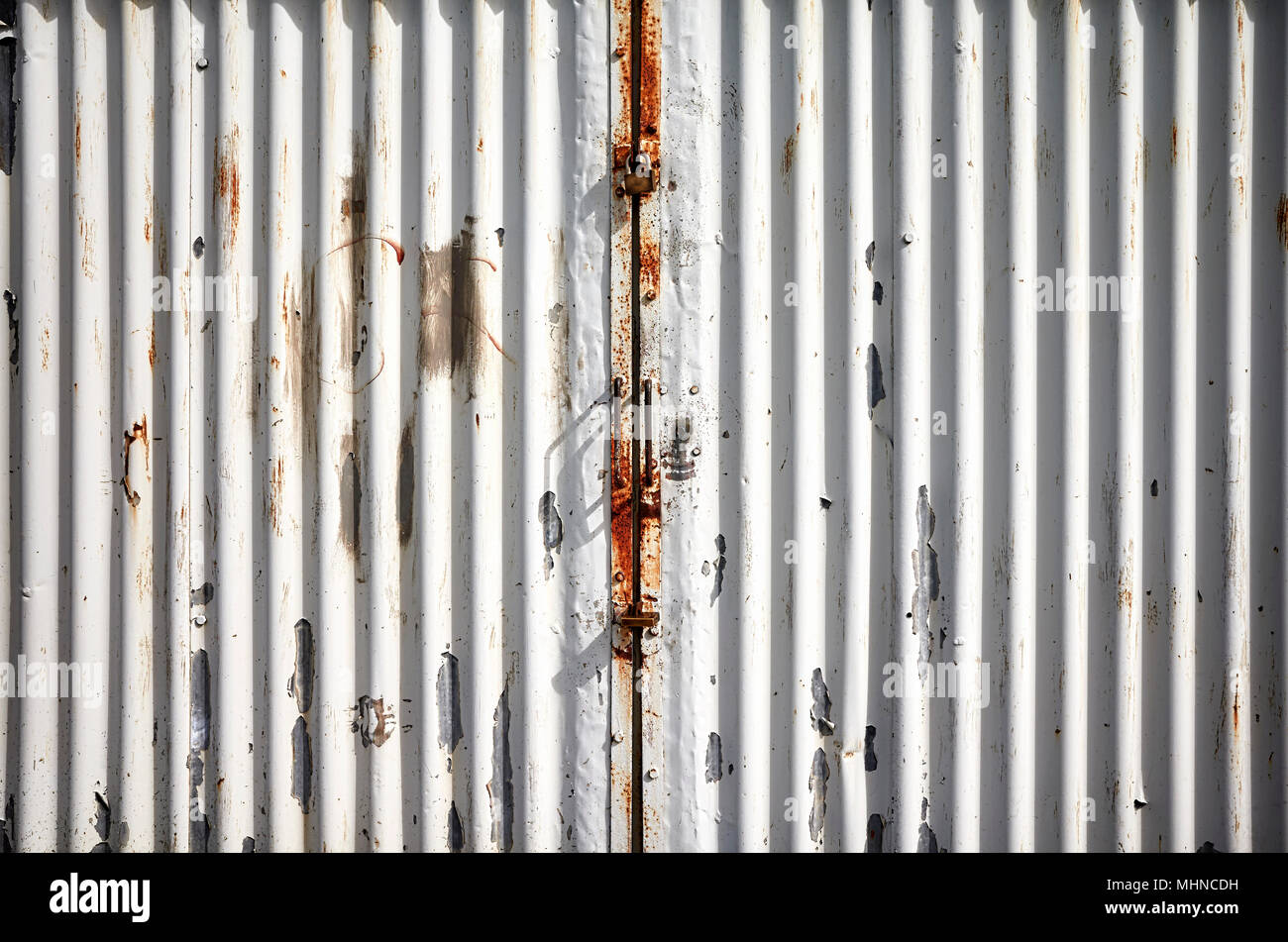 Garage corrugated metal door with peeling paint. Stock Photo