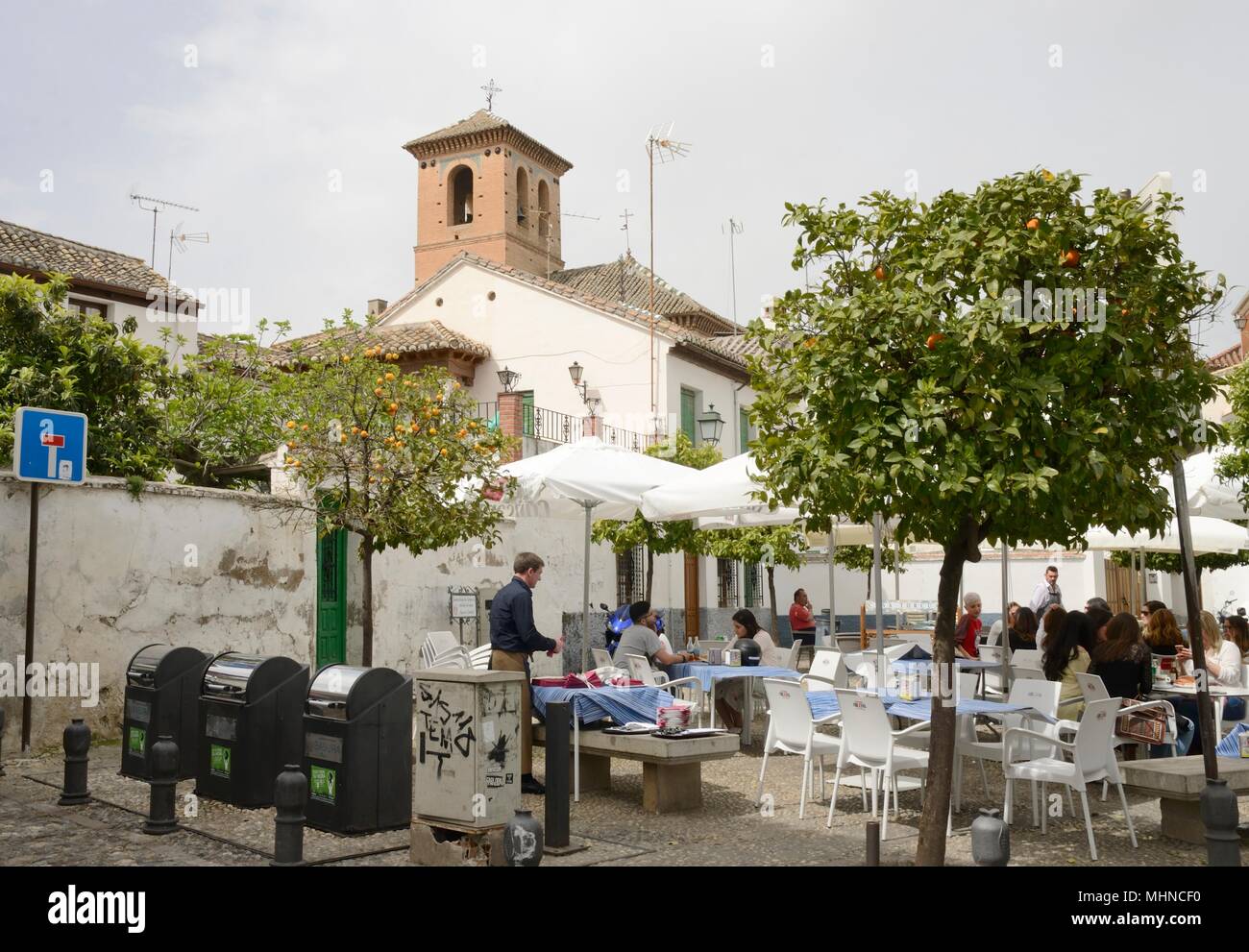 People at outdoors pub located in plaza of the popular Albaicin district, Granada, Andalusia, Spain. Stock Photo
