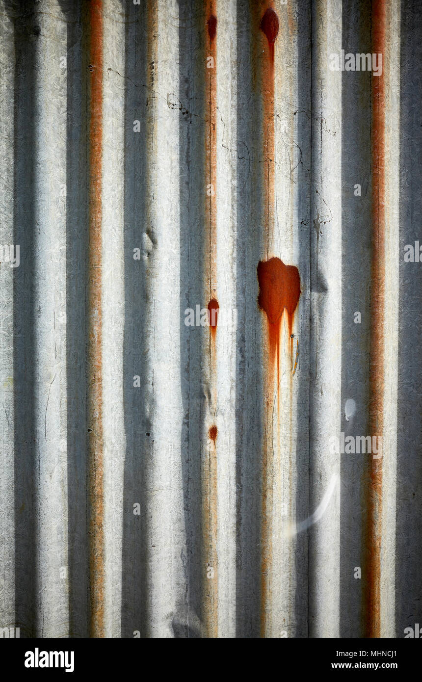 Weathered corrugated rusty metal wall, abstract background. Stock Photo