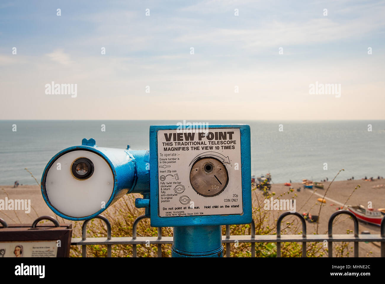 A traditional coin operated View Point telescope over looking the seafront of the village of Beer, Devon, England. Stock Photo