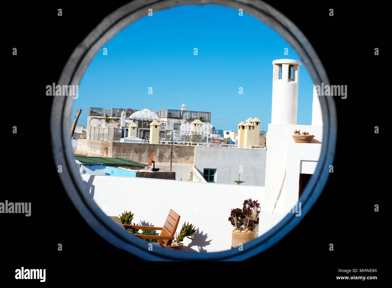 The Medina old town roof tops seen through a round window, Essaouira, Morocco, Africa. Stock Photo