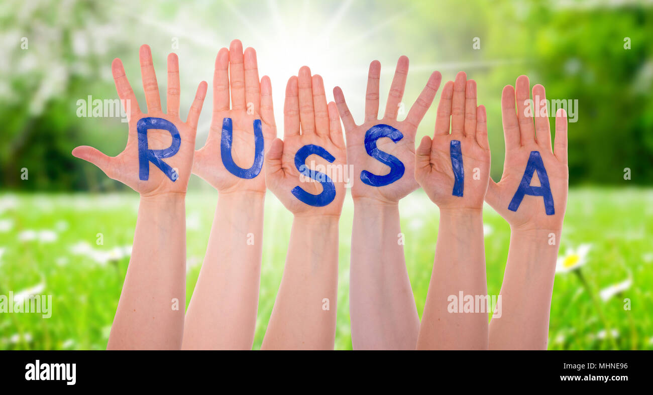 Hands With Russia, Sunny Grass Meadow Stock Photo