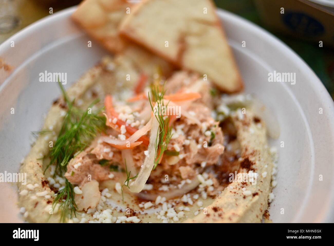 Seafood dip with hummus served with a side of crispy pita chips at The