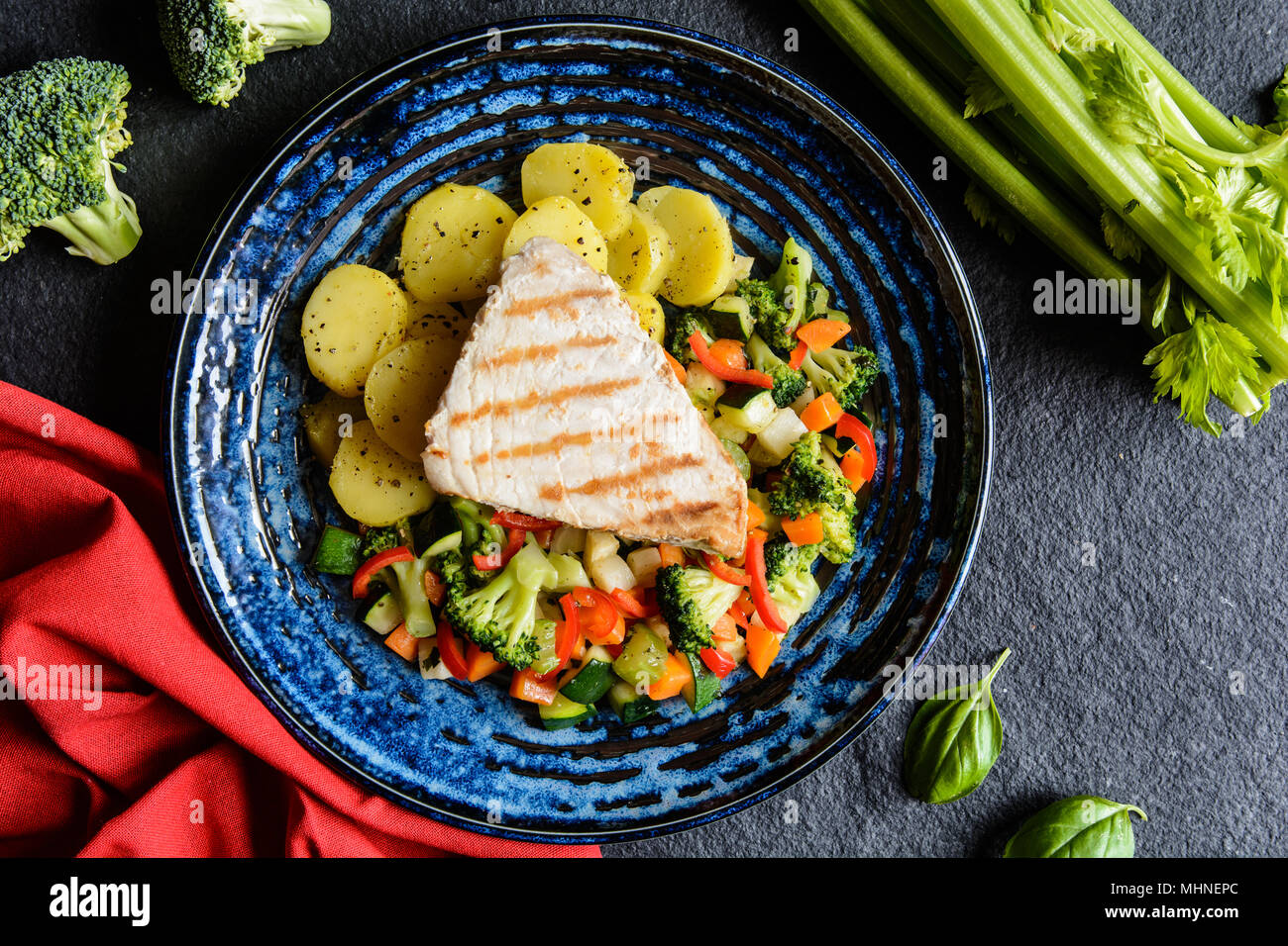 Grilled tuna steaks with steamed broccoli, red pepper, zucchini