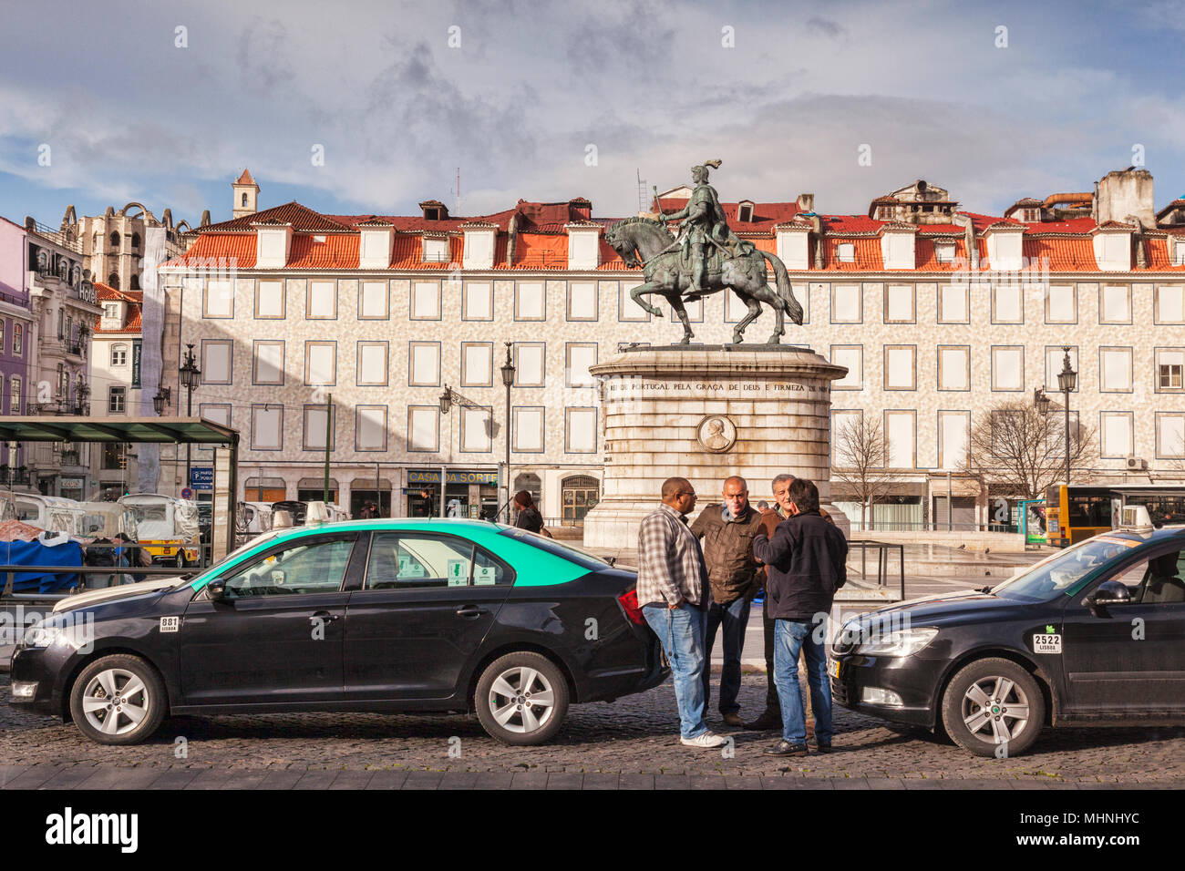 27 February 2018: Lisbon, Portugal - Taxi drivers chat as they wait for customers in Figueira Square. Stock Photo