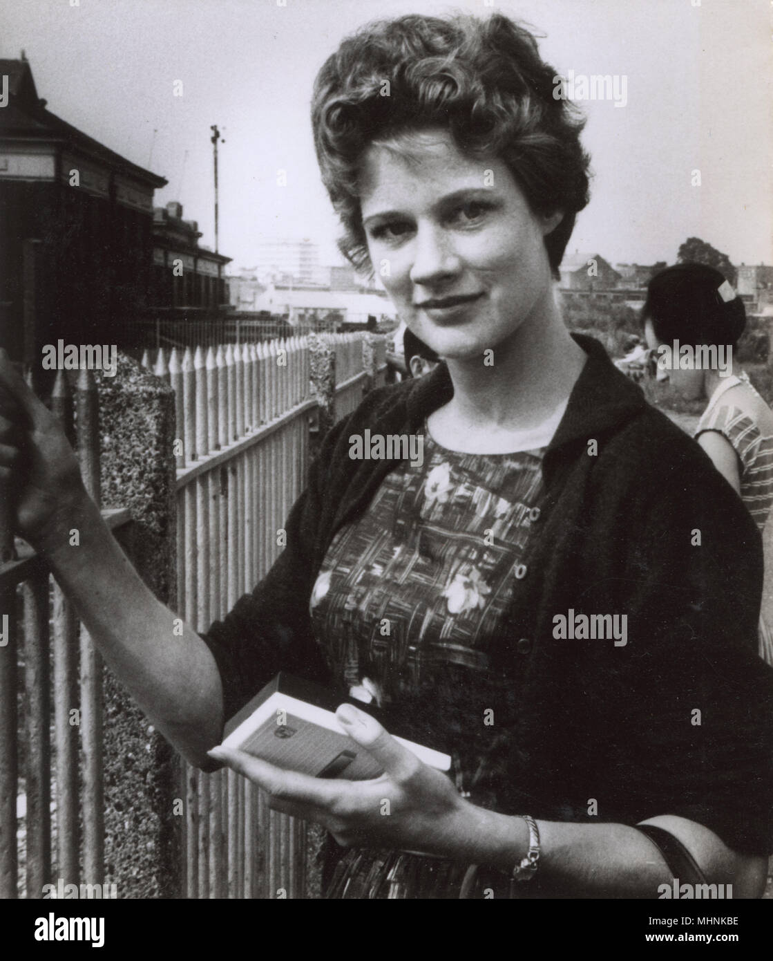 Pretty 1960s girl holding a Philips portable transistor radio.     Date: circa 1963 Stock Photo