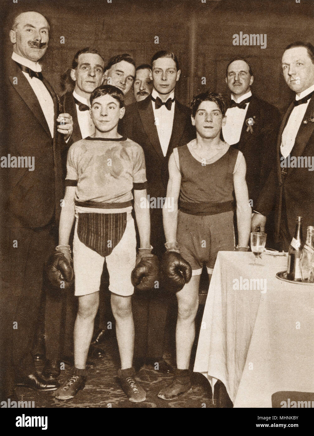Albert, Duke of York (1895-1952) (later King George VI), pictured with two contestants in the Stable Lads Boxing Tournament, which took place at the National Sporting Club in aid of St. Dunstan's (Charity set up to aid blind and visually-impaired veterans). All the leading racing stables were represented. Date: 1923 Stock Photo