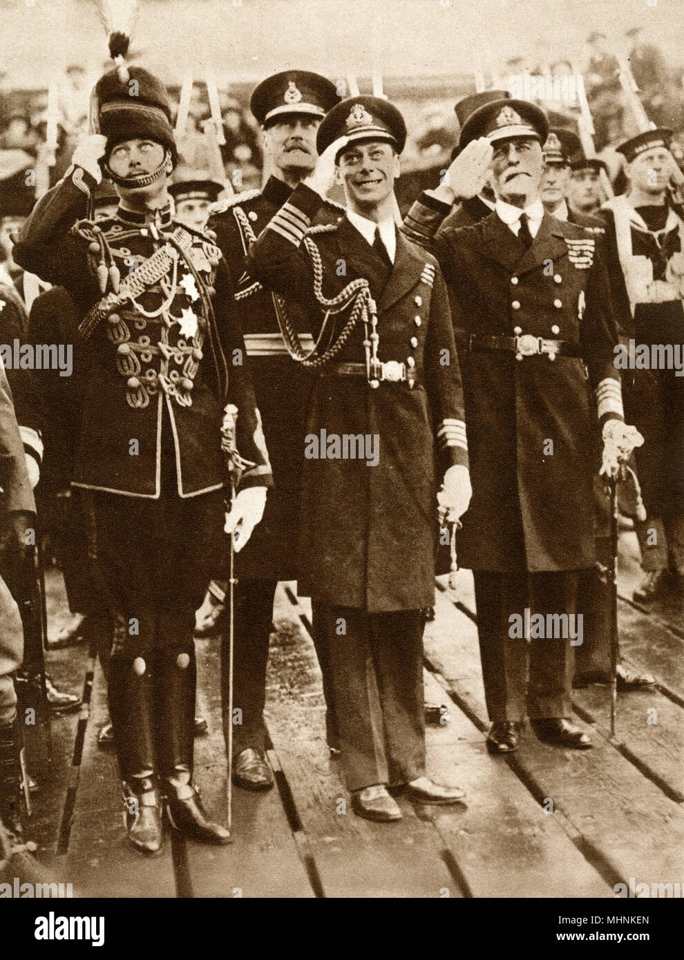 Edward Prince of Wales (1894-1972) (later King Edward VIII) and Prince Henry, Duke of Gloucester (1900-1974) salute the return of Albert, Duke of York (1895-1952) (later King George VI) from a seven-month Imperial Tour - October 1925. Arriving on HMS Repulse at Portsmouth Harbour.     Date: 1925 Stock Photo