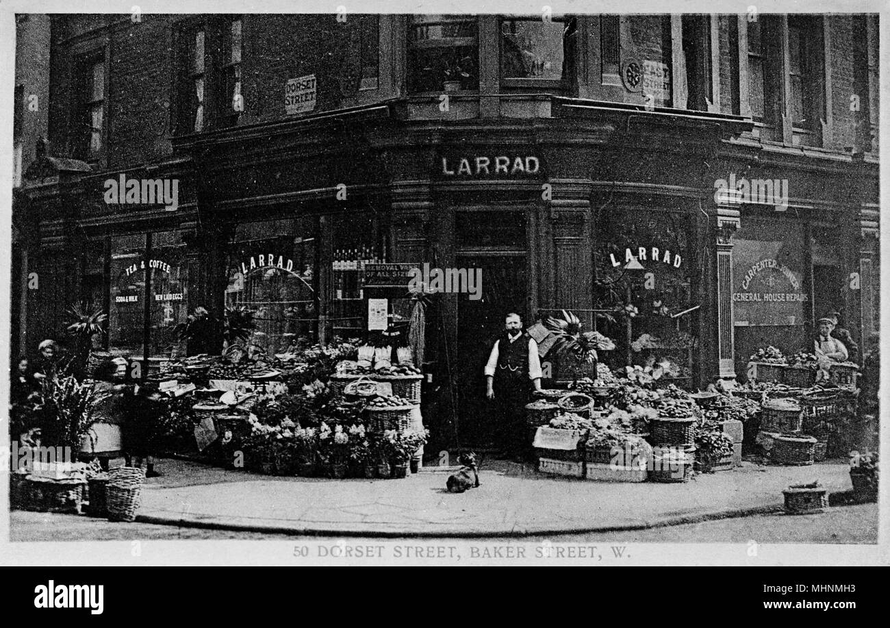 Large corner shop at 50 Dorset Street, Baker Street, London -- Larrad greengrocer, fruiterer and florist, with a large display of produce out on the pavement.      Date: circa 1910s Stock Photo