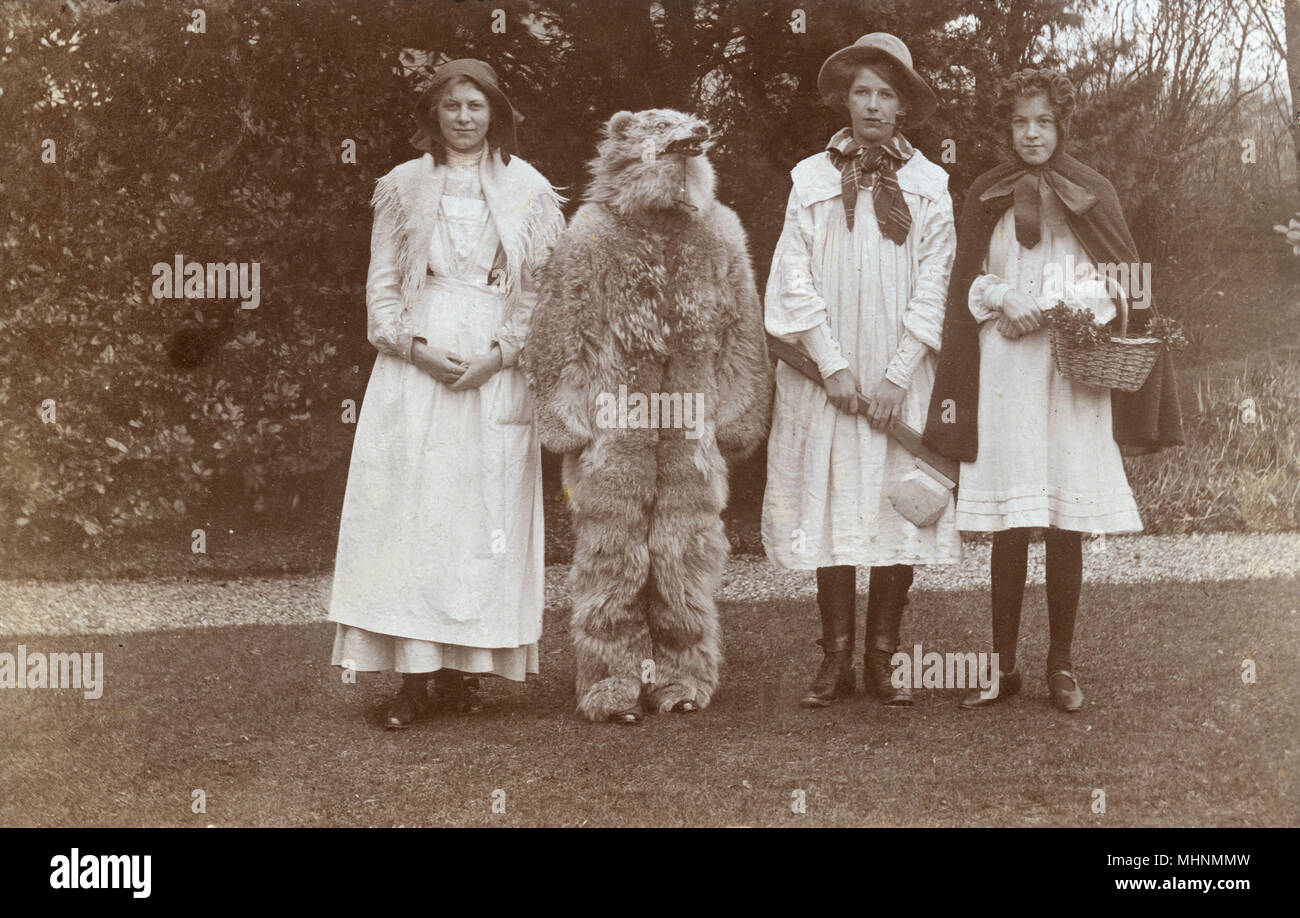 A quartet in fancy dress costume dressed up as the main characters in the fairy tale Little Red Riding Hood.  The wolf costume is particularly sinister.     Date: c.1910 Stock Photo