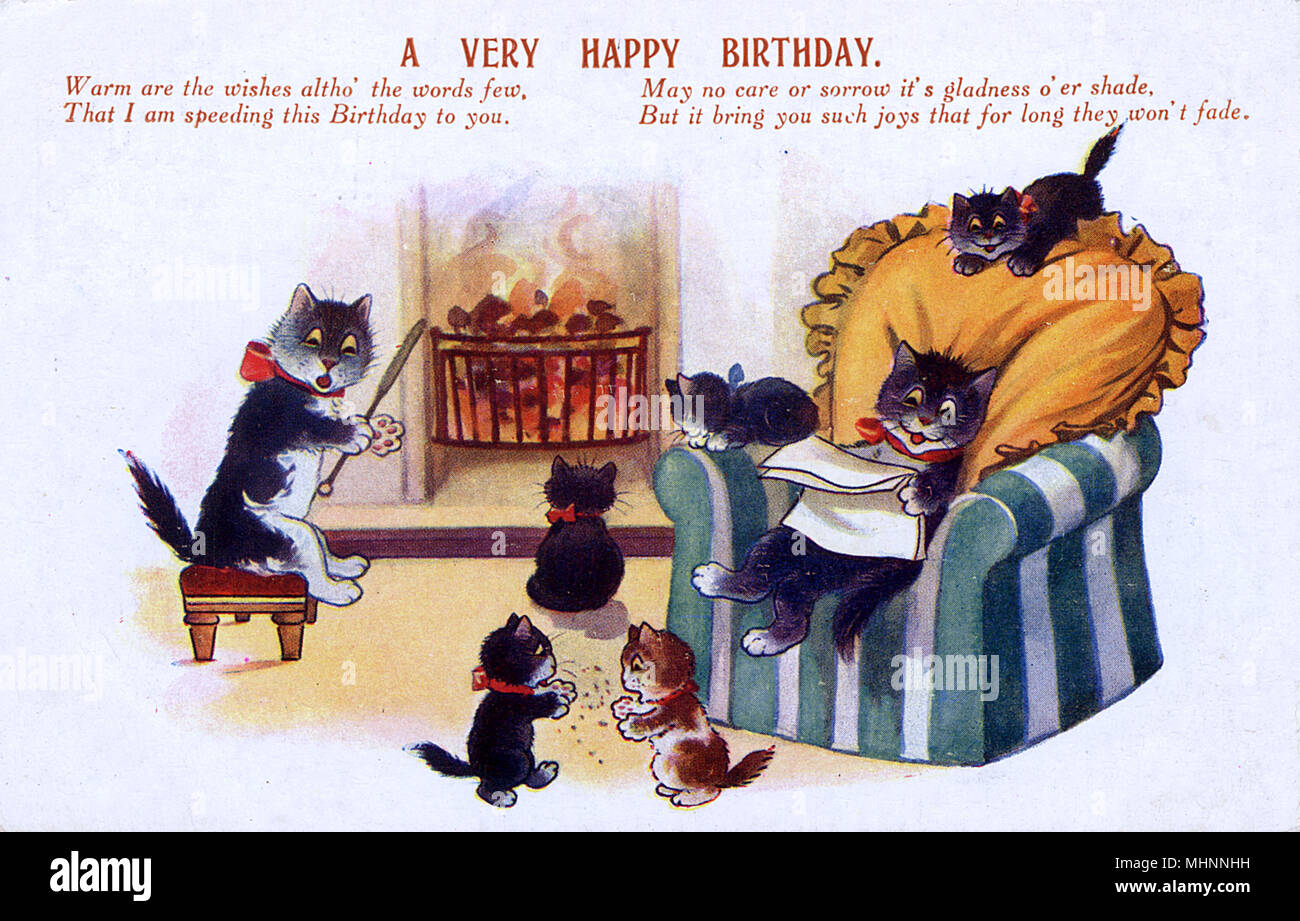 Birthday Greetings postcard - A family of Cats at home, sitting and playing around the fire.     Date: circa 1922 Stock Photo
