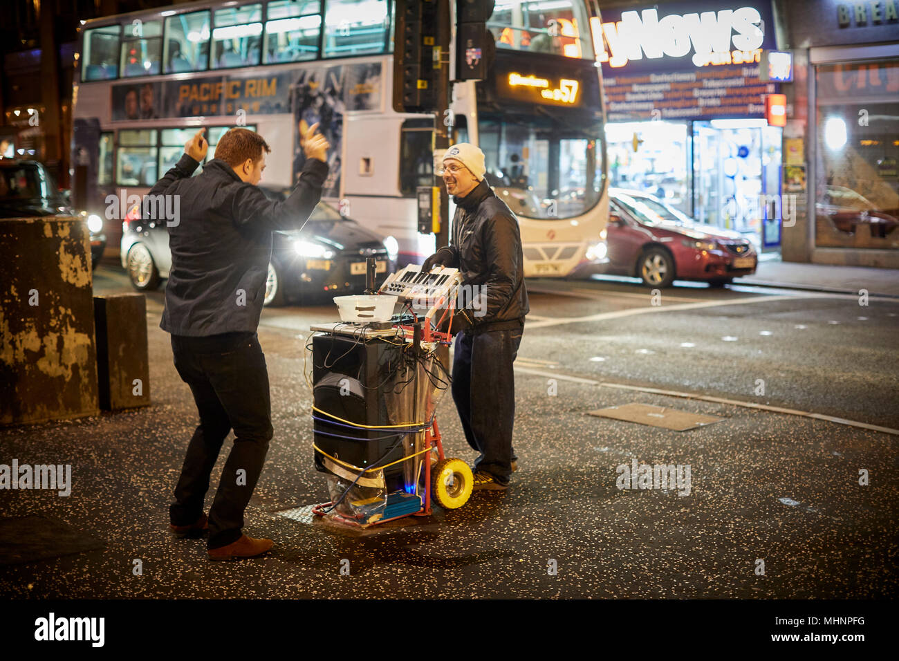 Glasgow in Scotland, Busker DJ drawing in late night crowds in the City Centre Stock Photo