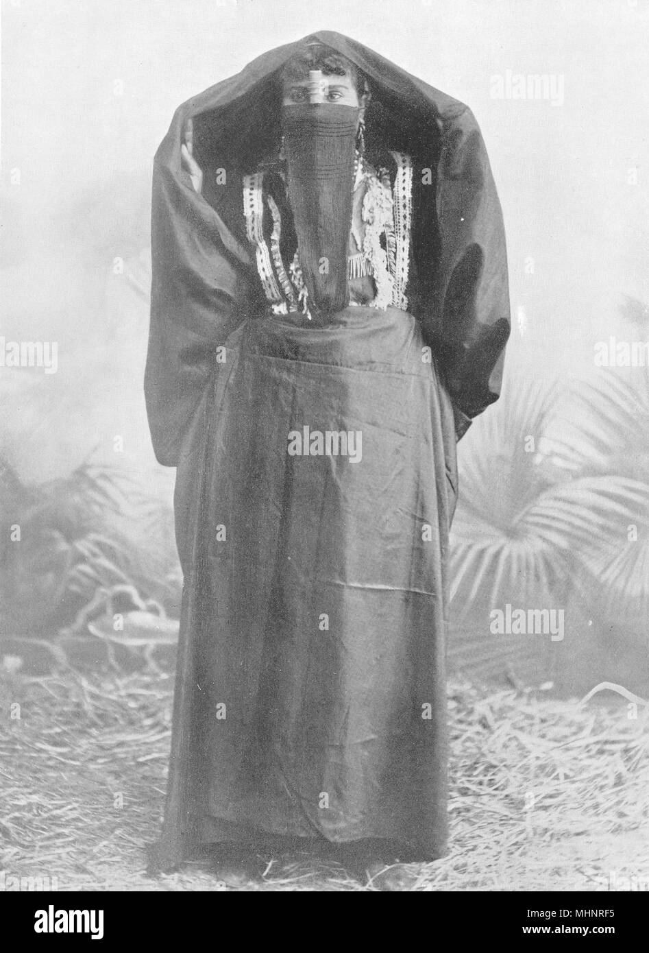 EGYPT. An Egyptian town woman in outdoor dress; yelek, yashmak, 'abaya 1900 Stock Photo