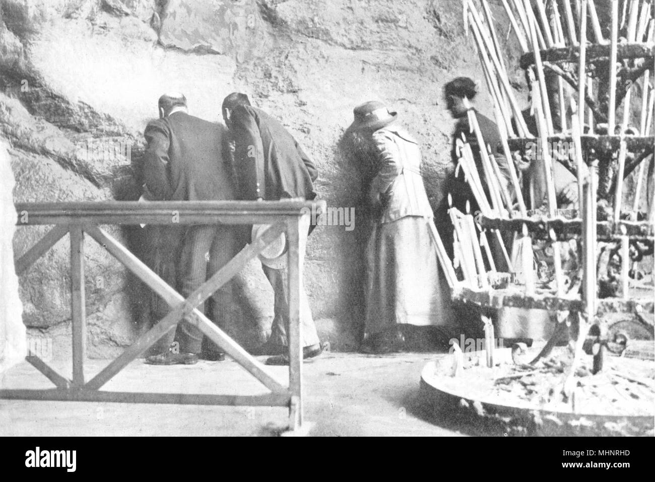 HAUTES-PYRÉNÉES. France. The Grotto, Lourdes; Pilgrims kiss the holy stone 1900 Stock Photo