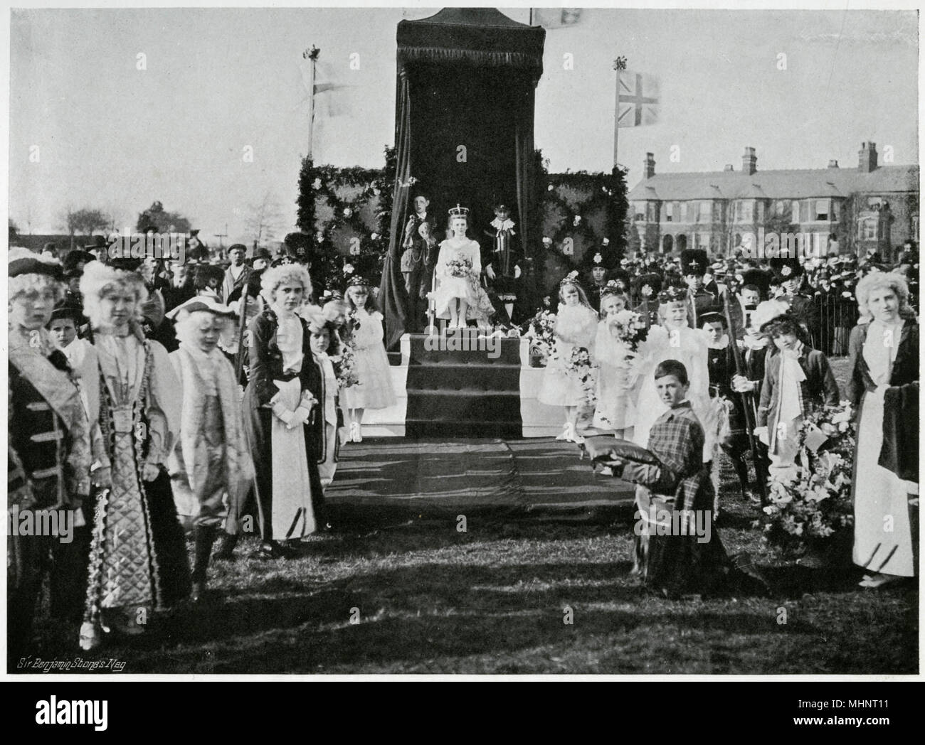 Enormous crowd of spectators watch as the coronation of the to be 'Queen of the May' takes place with elaborate ceremonial.     Date: 1902 Stock Photo