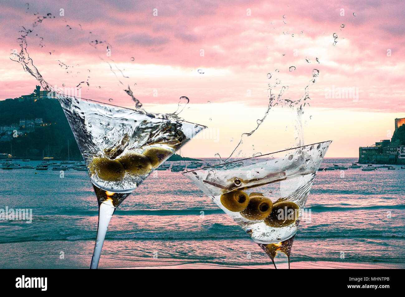 Cocktails with splashining martini on a sunset beach Stock Photo Alamy