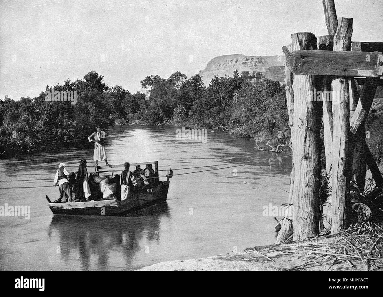 People crossing the River Jordan, Holy Land Stock Photo