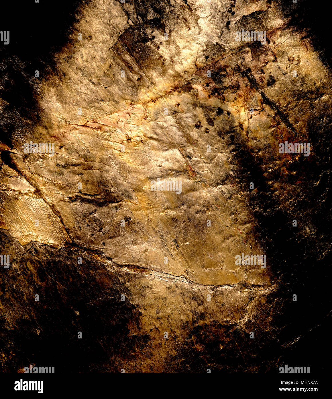 Stone background with surface structure and metallic gold tones. Stock Photo