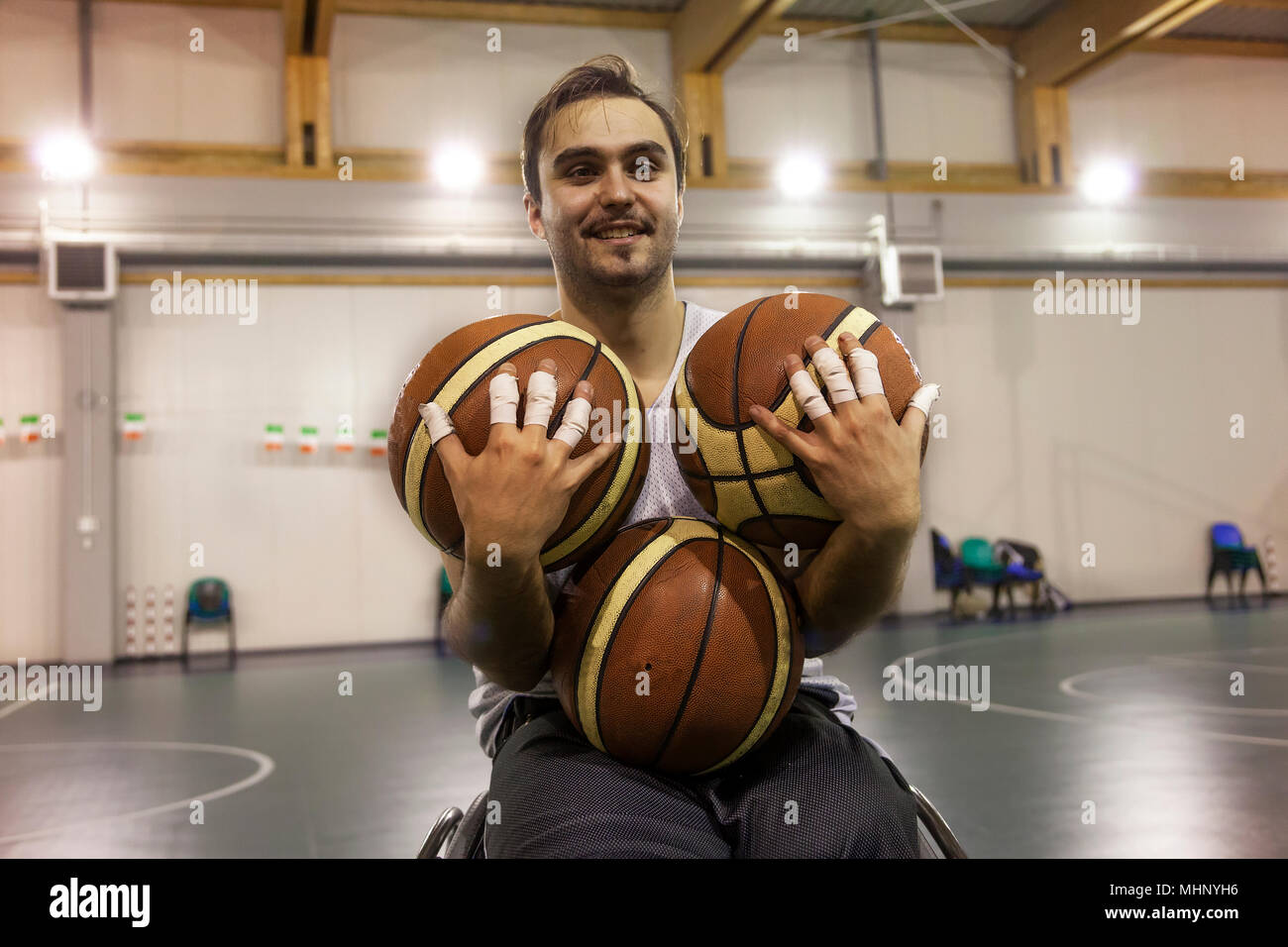 disabled sport men in action while playing indoor basketball at a basketball court Stock Photo