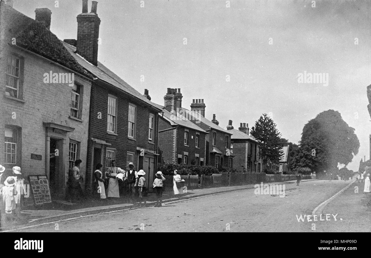 Street scene in the village of Weeley, Essex, with a group of people on the left.      Date: circa 1910s Stock Photo