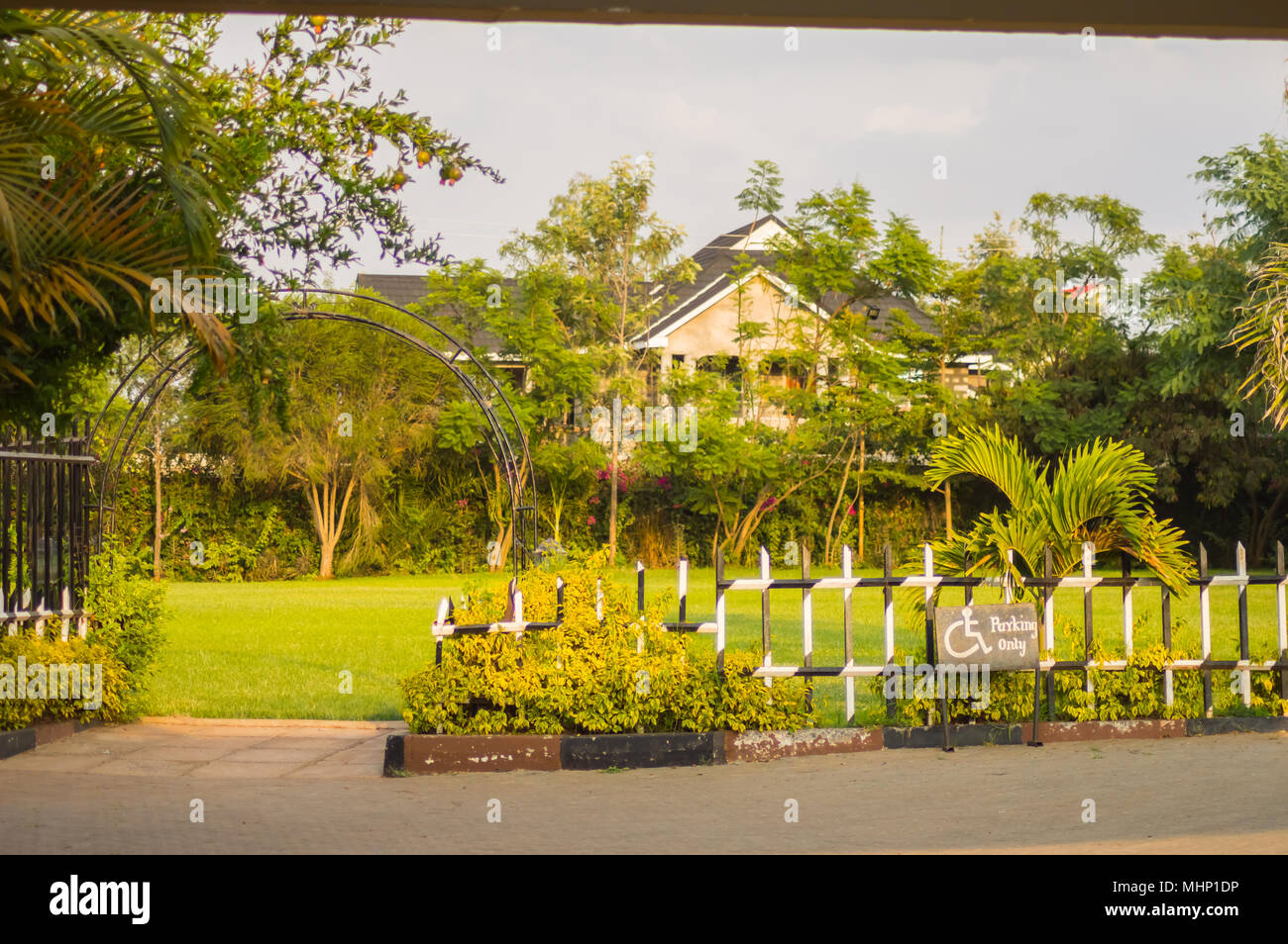 Entrance to a flower park with a barrier and an ark in the city of Nairobi Kenya Stock Photo