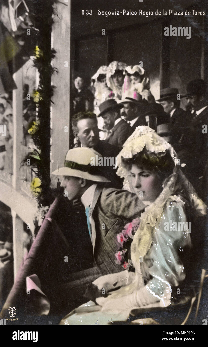 King Alfonso XIII of Spain and his consort, Victoria Eugenie of Battenberg, seen here in the royal box of the bullring in Segovia.      Date: circa 1910 Stock Photo