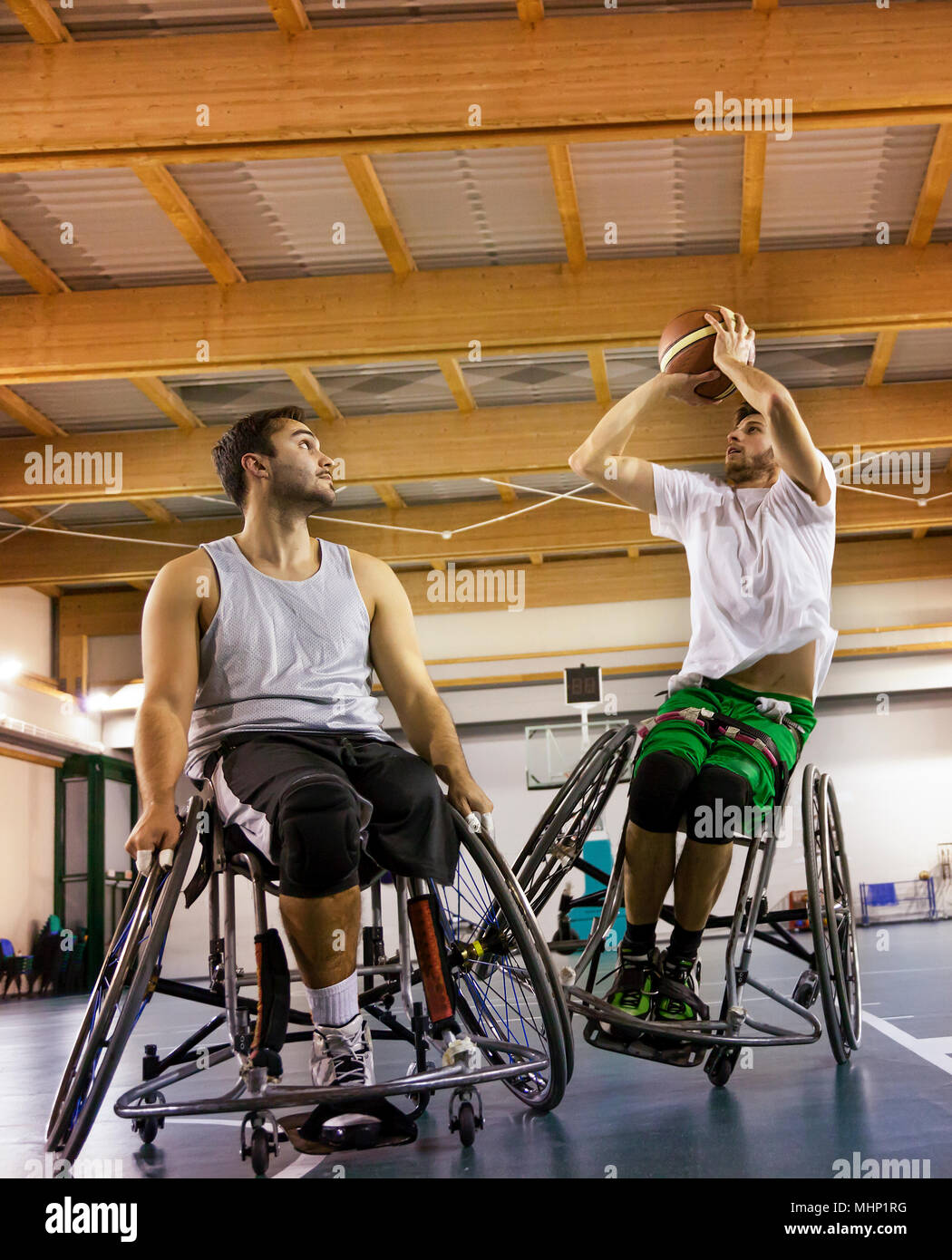 disabled sport men in action while playing indoor basketball at a basketball court Stock Photo