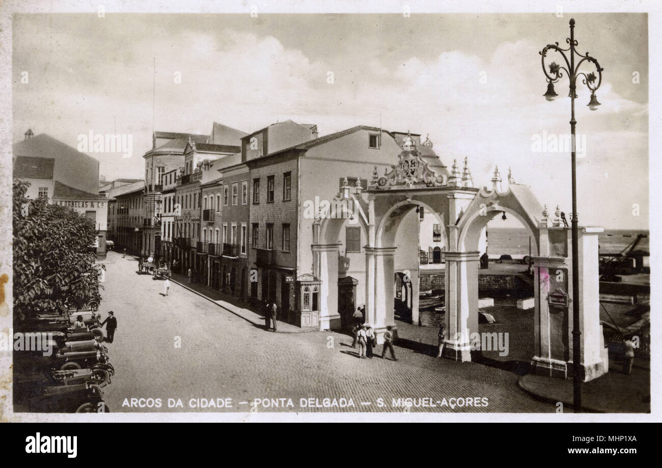 View of Joao Franco Street, Ponta Delgada, Sao Miguel Island, Azores, Atlantic Ocean, with the city arches on the right.     Date: circa 1920s Stock Photo