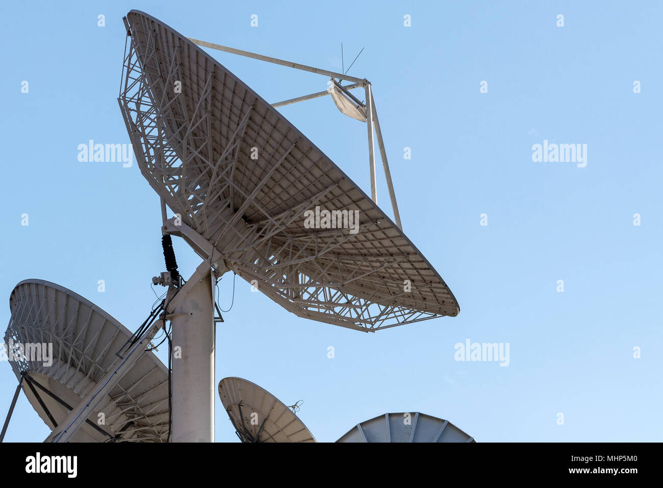 satellite Communication Antenna on the light blue sky background Stock