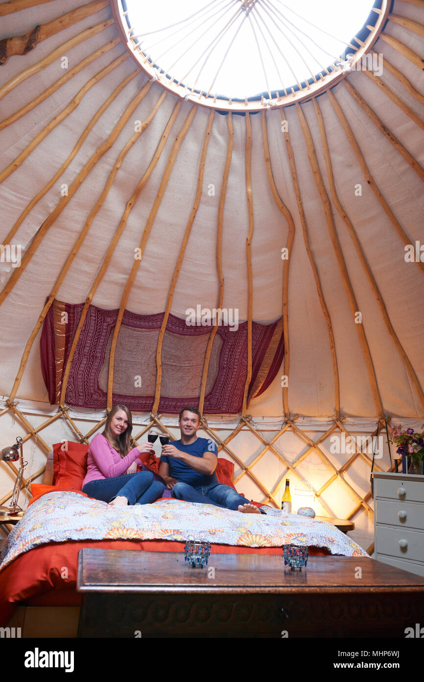Couple Enjoying Luxury Camping Holiday In Yurt Stock Photo