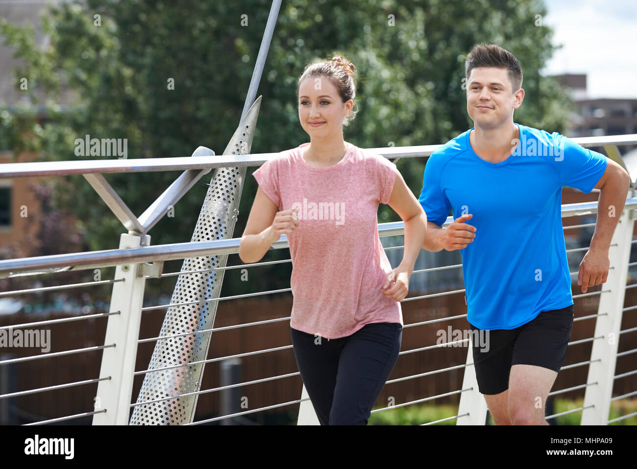 Young Couple Exercising In Urban Environment Stock Photo