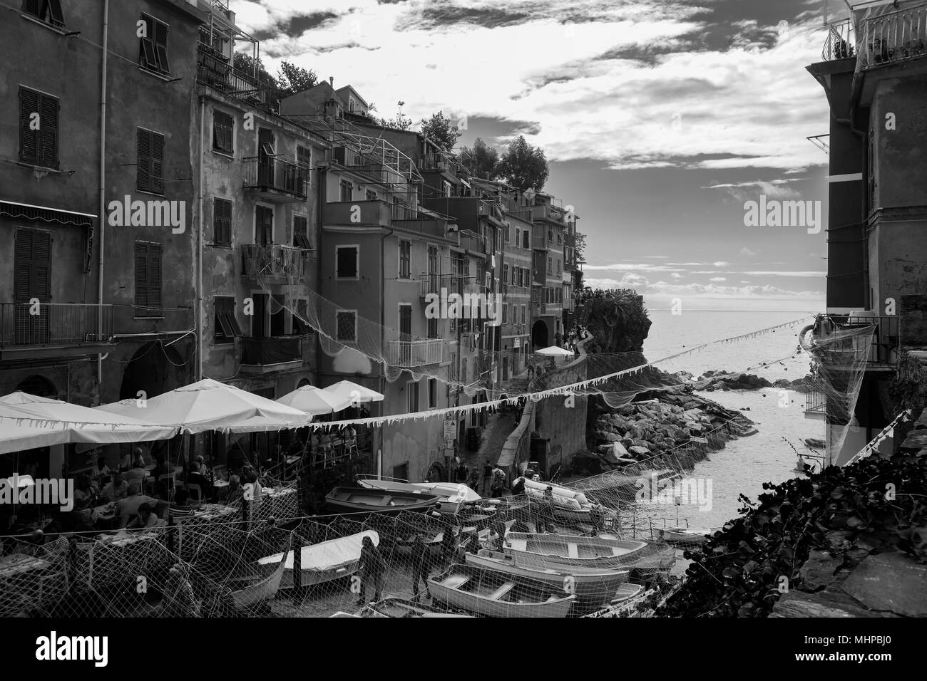 Via di San Giacomo and the tiny harbour, Riomaggiore, Cinque Terre, Liguria, Italy: black and white version Stock Photo