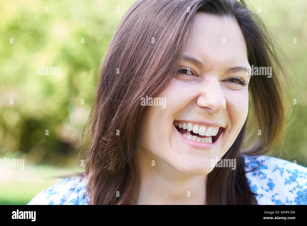 Outdoor Head And Shoulders Portrait Of Laughing Young Woman Stock Photo ...