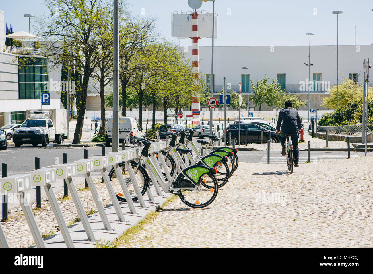 Portugal, Lisbon 29 april 2018: city bicycles or alternative ecological public transport. A person takes a bicycle for rent. Stock Photo