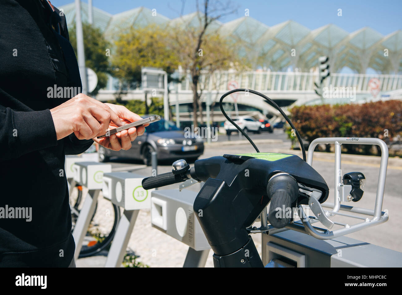 Portugal, Lisbon 29 april 2018: man rents bicycle using the mobile app on your phone Stock Photo