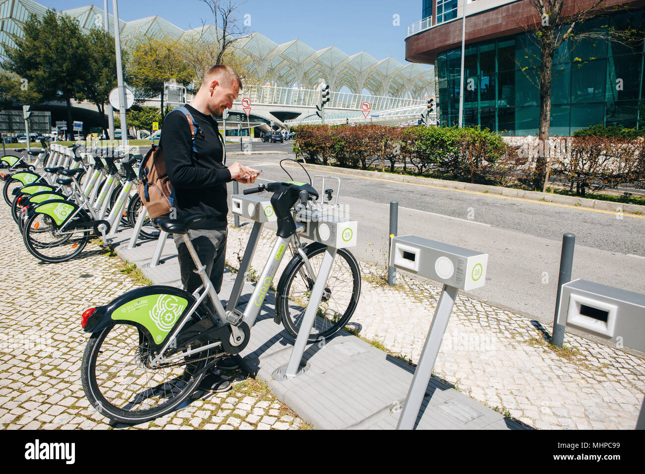 Portugal, Lisbon 29 april 2018: man rents bicycle using the mobile app on your phone Stock Photo